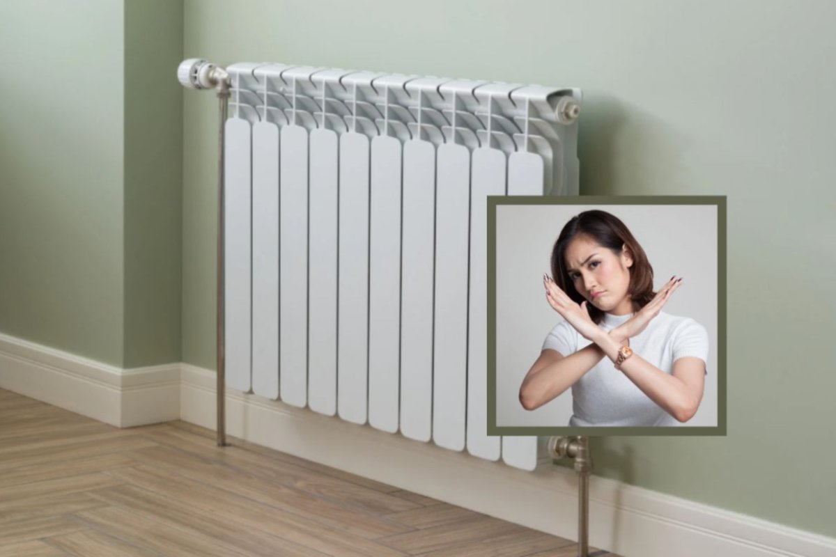 termosifone alla parete e donna che dice di no con le braccia a x